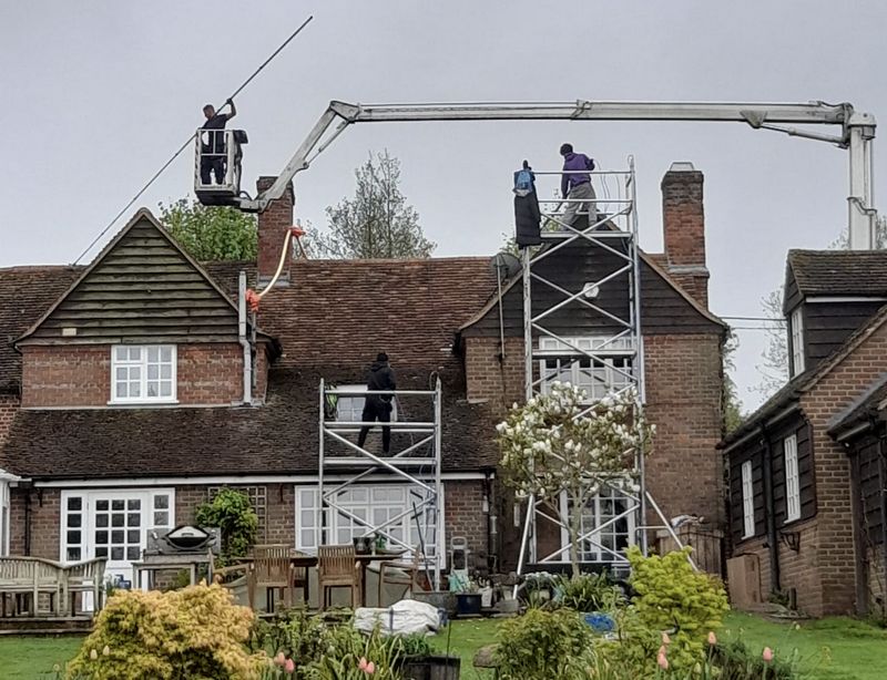 The Roof Moss Cleaners using cherry picker and scaffolding to clean roof safely and professionally in Wilton, Wiltshire