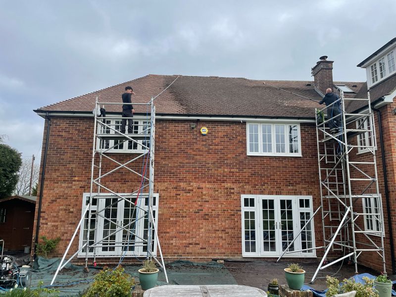 Roof cleaning carried out safely from scaffold towers by The Roof Moss Cleaners in Wilton